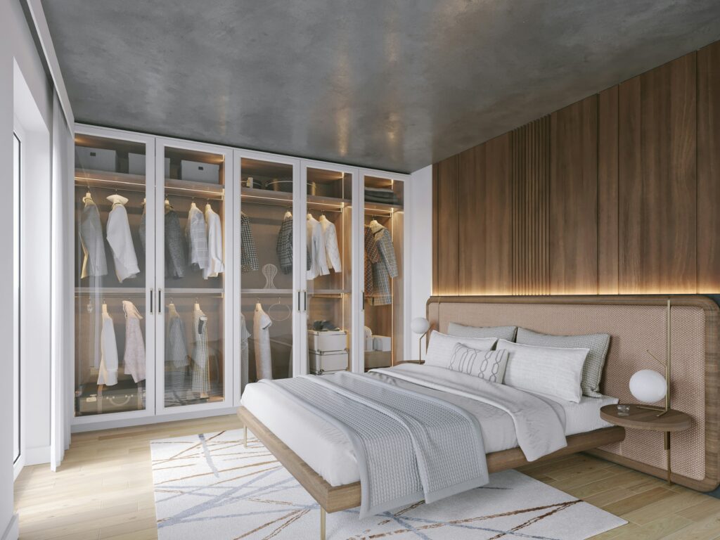 Minimalist bedroom with warm wood accents and an illuminated open wardrobe.